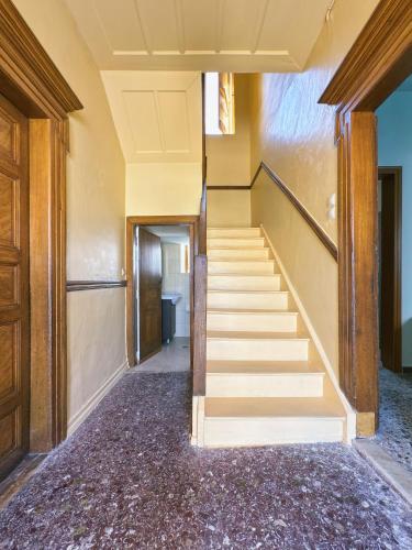 an empty hallway with stairs in a building at Traditional Stone House in Kranidi