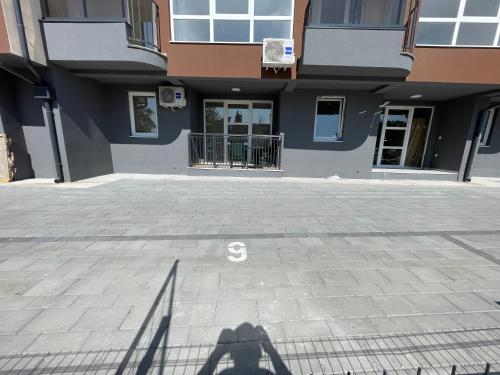 a shadow of a person standing in front of a building at Dora 2 in Veliko Gradište