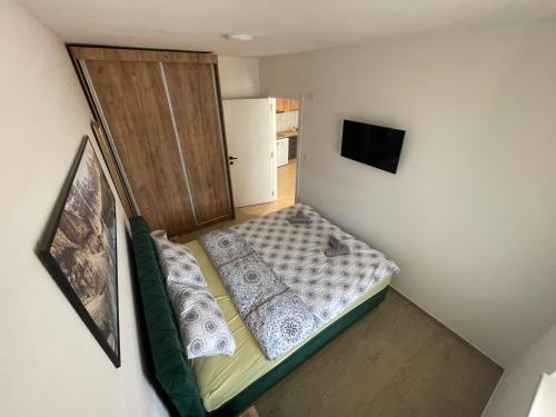 a small bedroom with a bed and a door at Dora 2 in Veliko Gradište