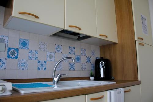 a kitchen with a sink and a counter top at Summer House in Buonfornello