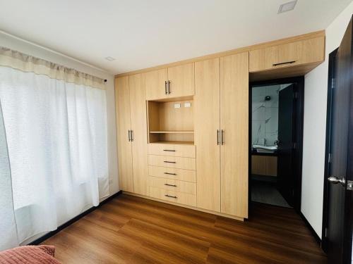 a room with a large wooden cabinet with a mirror at Sony Cel's Little Corner in Azogues