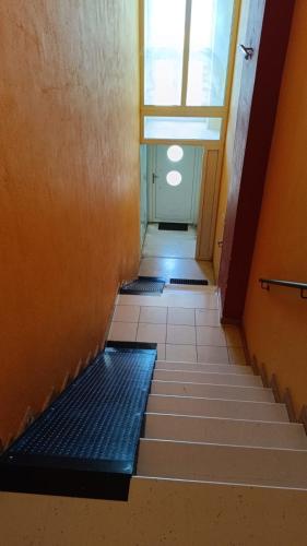 a hallway with a staircase with a window and a door at Igoumenitsa heart flats to let Mariasroom studios appart seaside-city Spyropoulos in Igoumenitsa