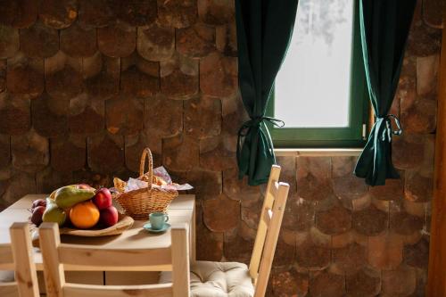 a table with a bowl of fruit and two chairs at Golavškov mlin in Prebold