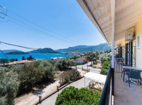 a balcony with a view of the water at Alpha Studios in Nydri