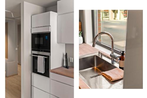 a kitchen with a sink and a microwave at Heart of Tønsberg, Newly renovated, Room for 6 people! in Tønsberg