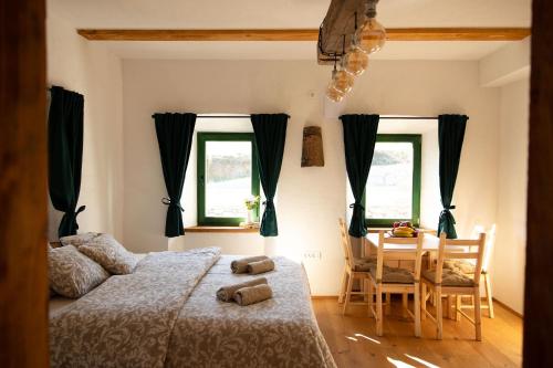 a bedroom with a bed and a table and chairs at Golavškov mlin in Prebold