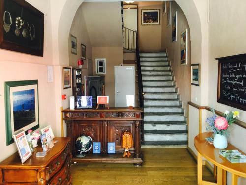 a hallway with a staircase in a house at Hotel Restaurant L'Europe in Saint-Florent