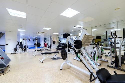 a gym with lots of treadmills and machines at Duvabitat Apartments in Port de Pollensa