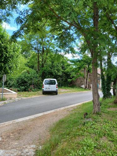 a white van parked on the side of a road at cosy logis et son écrin de verdure in Cordes-sur-Ciel
