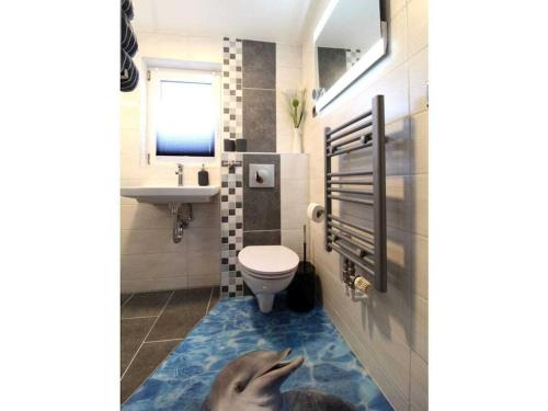 a bathroom with a dolphin on the floor at Holiday home in Husum with swimming pool in Husum