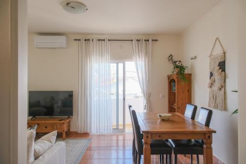a dining room with a table and a living room at Charming Lagos Stay - Walk to Beach & Historic Centre in Lagos