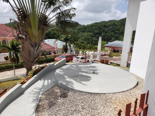 a patio with a table and a palm tree at Mountain View Escape in Mandeville