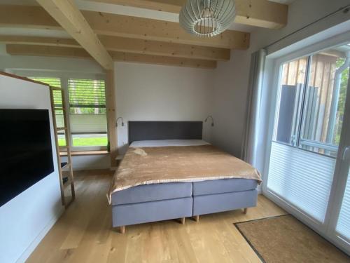 a bedroom with a bed and a large window at Holiday home in Zingst with swimming pool in Zingst