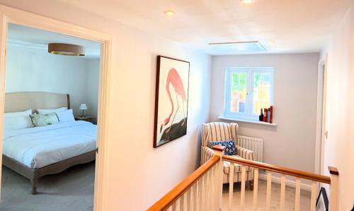 a bedroom with a bed and a chair at Silverstone Paddock Retreat in Silverstone