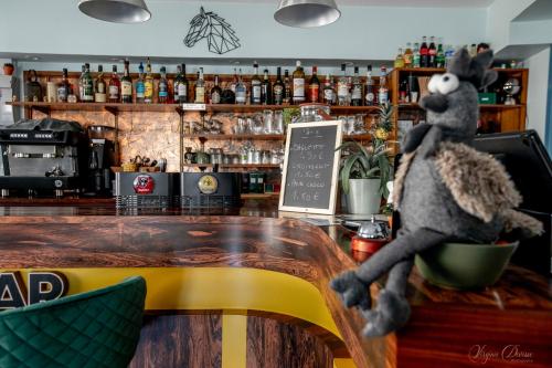 a stuffed animal sitting on the counter of a bar at L Escale in Ports
