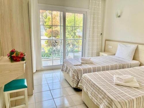 a hotel room with two beds and a window at Mermaid in Marmaris
