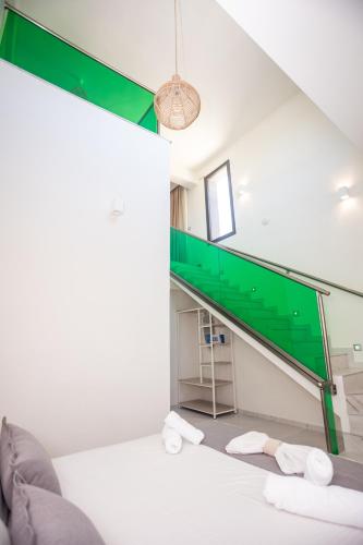 a living room with a staircase and a couch at Amalia Deluxe Villas in Nea Vrasna
