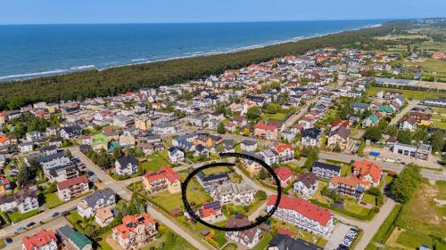 an aerial view of a town next to the ocean at Fajne Apartamenty - Karwia - Blisko Plaży - Komfort i Cisza in Karwia