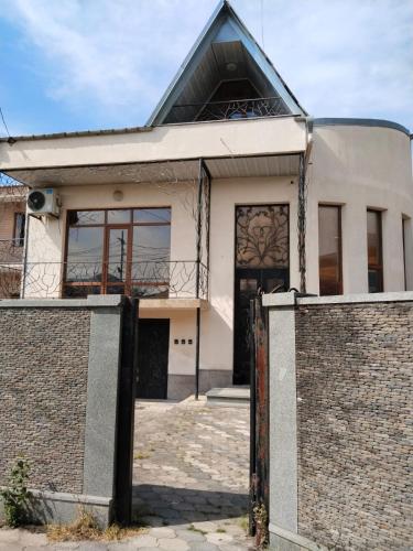a white house with a fence in front of it at Villa Vanila in Kutaisi