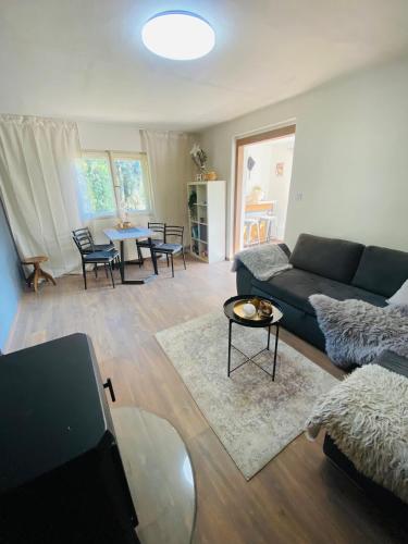 a living room with a couch and a table at Chatička Žloukovice in Nižbor