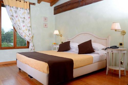 Postel nebo postele na pokoji v ubytování Albergo Dimora Storica Antica Hostelleria