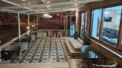 a restaurant with a lobby with a table and chairs at Otel DENİZYILDIZI CENTRUM in Fethiye