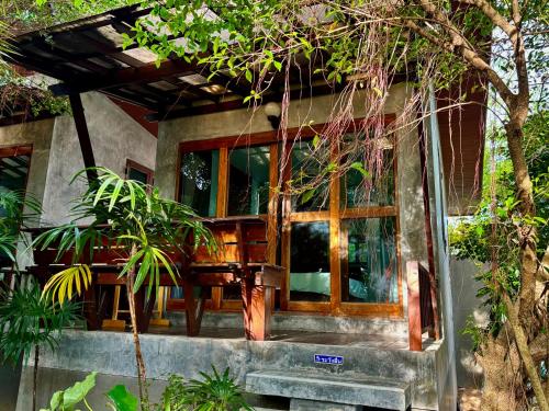a house with a large window on the side of it at Chook Dee Resort in Baan Tai