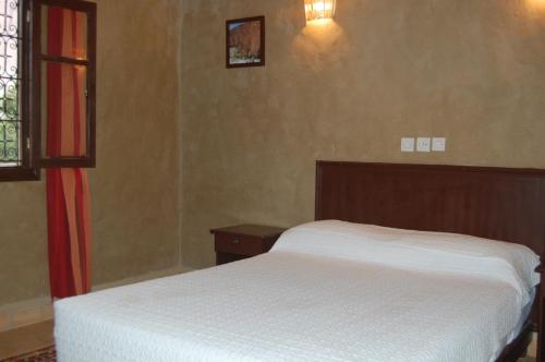 Postel nebo postele na pokoji v ubytování Auberge Amellagou