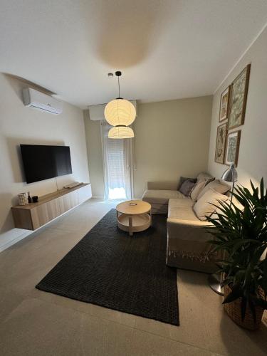 a living room with a couch and a table at Appartamenti a Carpi in Carpi