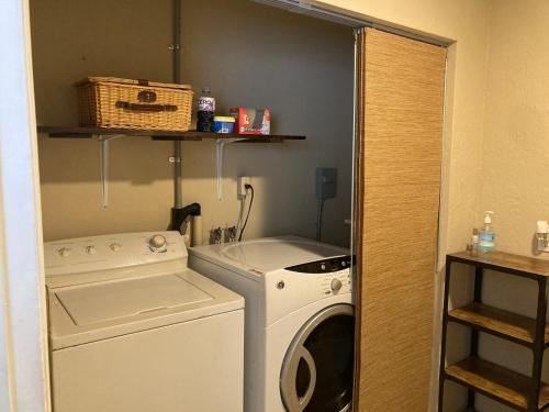 a laundry room with a washing machine and a washer at Englewood BeachHouse in Englewood