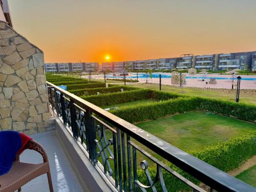 a balcony with a view of a pool and a resort at شاليه بلومار السخنة blumar wadi degla in Ain Sokhna