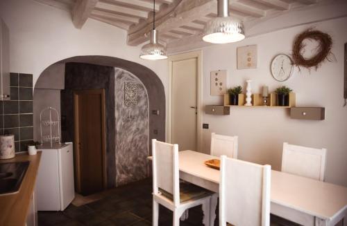a kitchen with a table and chairs in a room at Mecana Home - 20 minuti dalle terme di Saturnia in Manciano