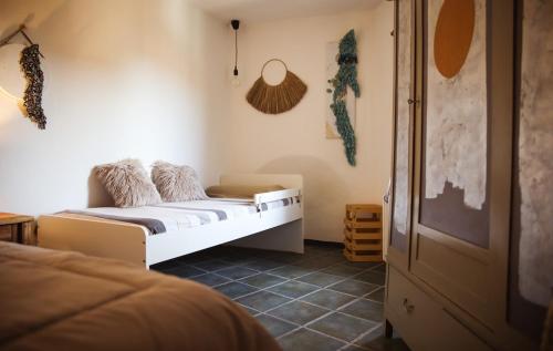a bedroom with a white bed and a room at Mecana Home - 20 minuti dalle terme di Saturnia in Manciano