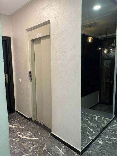 a hallway with a door and a mirror in a building at TheCasaEdition Gauthier Residency City Center in Casablanca