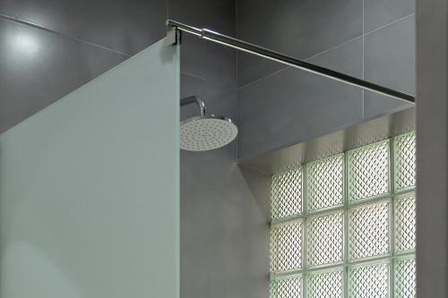 a bathroom with a shower with a glass window at DilijanInn Hotel and Restaurant in Dilijan