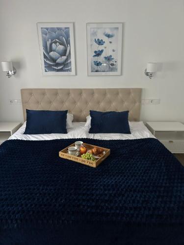 a tray of food sitting on top of a bed at A top-floor modern apartment Located 100 meters from the beach in Fuengirola