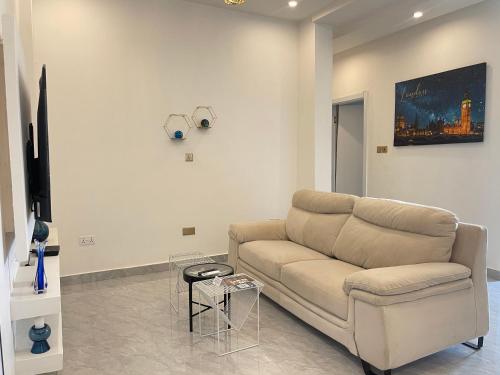 a living room with a couch and a table at Kassardjian Apartments in Accra