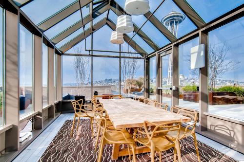 a dining room with a table and chairs and windows at Speechless In Seattle - #1 Location - 2BR - Free Parking - VR1 in Seattle