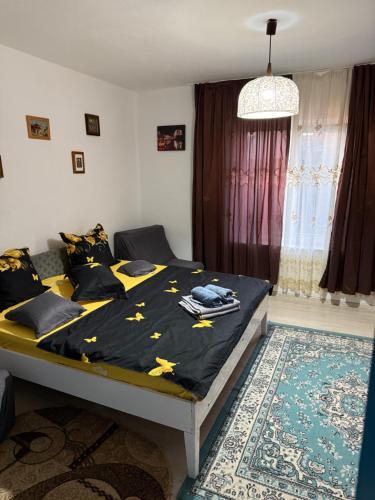 a bedroom with a bed with a black blanket with stars on it at Casuta Alga Sulina in Sulina