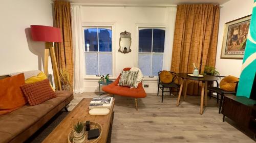 a living room with a couch and a table at Modern 1 Bed-Theatre, City Stay in Wolverhampton