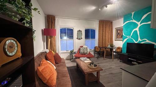 a living room with a couch and a table at Modern 1 Bed-Theatre, City Stay in Wolverhampton