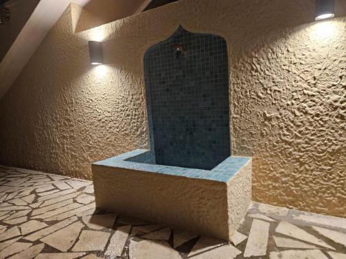 a bathroom with a shower in a wall with a mirror at Nomad Montenegro in Topla