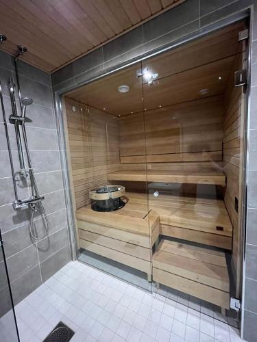 a bathroom with a shower with a tub at Seaside Escape Oulu in Oulu