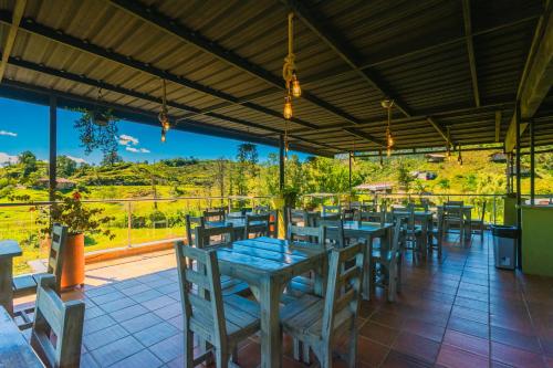 a restaurant with tables and chairs and a view at Hotel Bambu Guatape in Guatapé