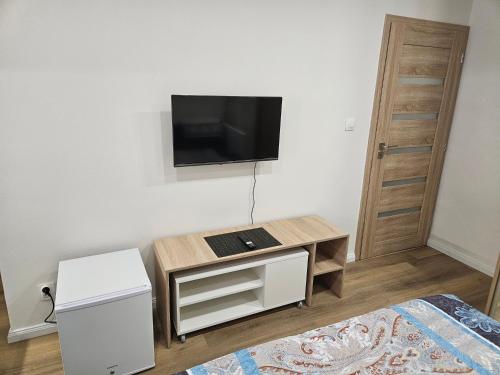 a living room with a tv on a wall at Central apartmán in Spišská Nová Ves