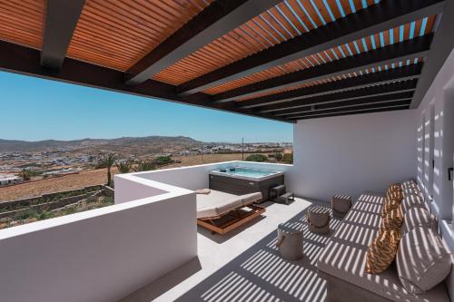 a view from the balcony of a house with a swimming pool at Noir Mykonos in Mýkonos City