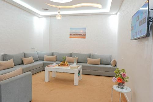 a living room with a couch and a table at Résidence America in Dakhla
