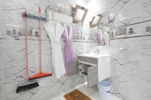 a white bathroom with a sink and a mirror at Résidence America in Dakhla