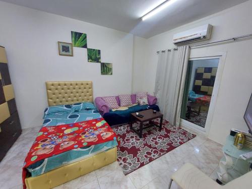 a small bedroom with a bed and a couch at Al Mohairi Tower-Cool Place for ur Stay-Well Furnished Studio in Ajman 