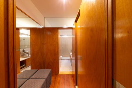 a small room with a bed and a bathroom at 125 House - Swimming Pool, Tennis, Golf & Nature in Esposende